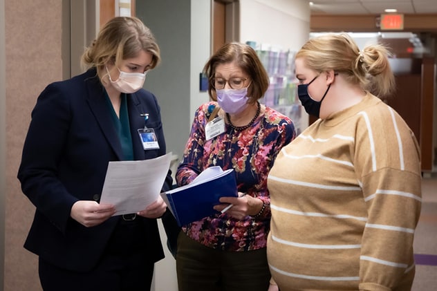 Breast and Melanoma Surgical Oncology team member collaborate verbally on a care question.